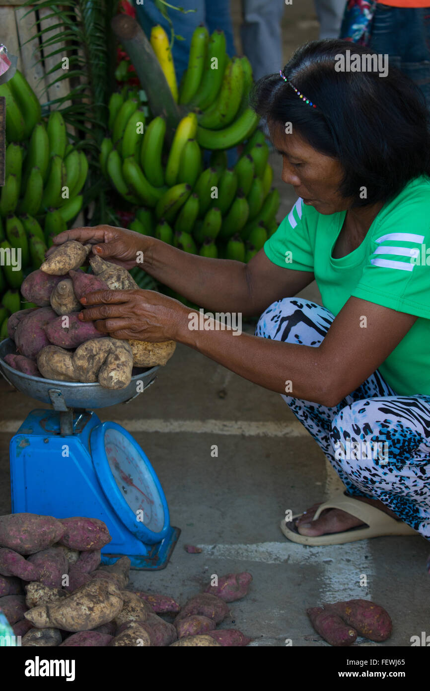Un filippino womem pesa Patate dolci note come Camote o Kamote nelle Filippine Foto Stock