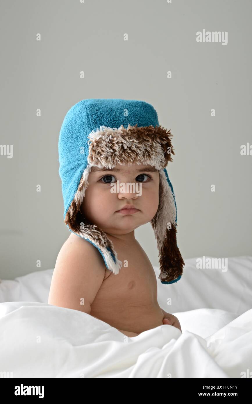 Dieci mesi di bambina indossa un cappello invernale Foto Stock