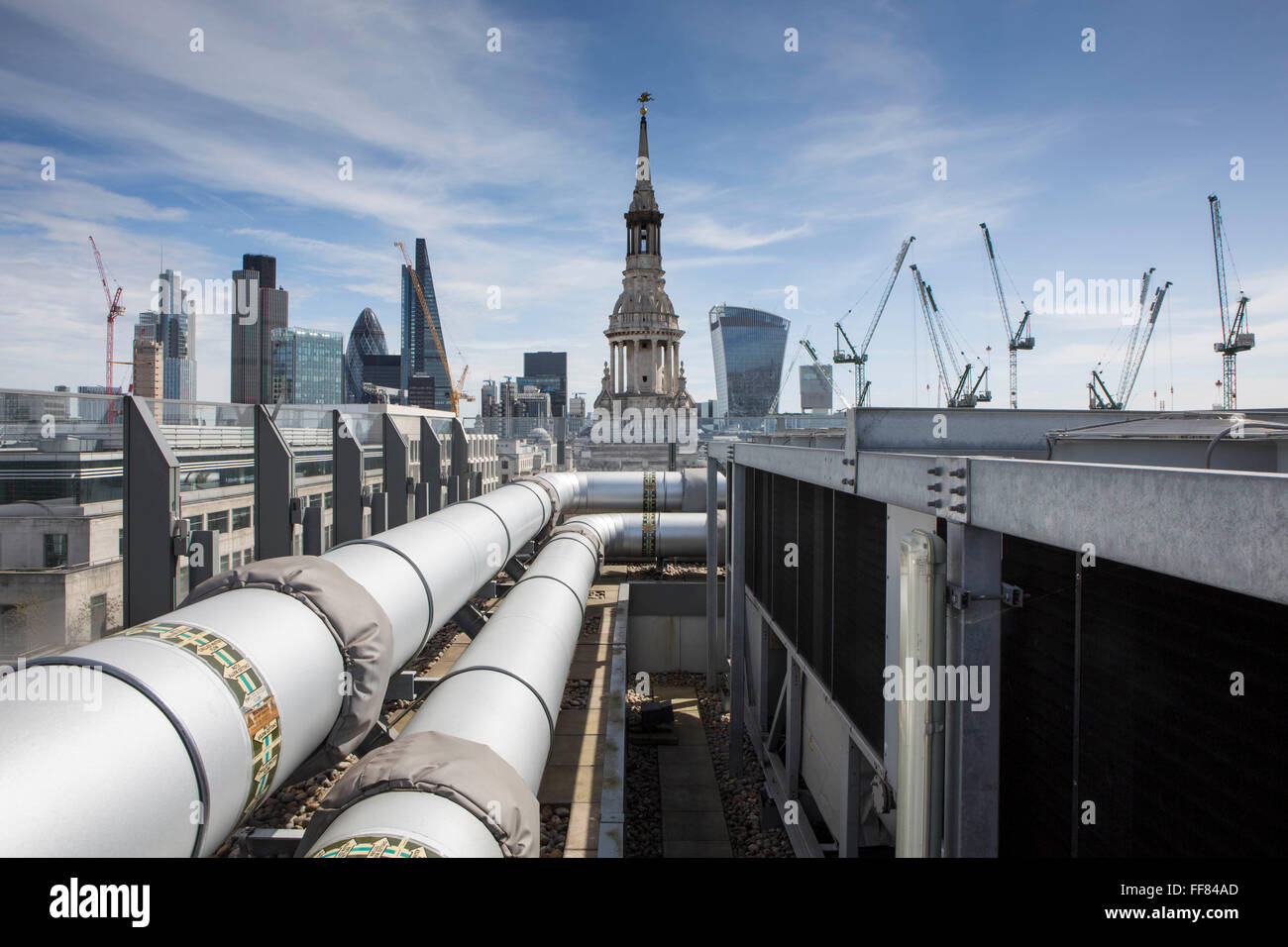 La guglia di St Mary-le-Bow attraverso la pipeworks sul tetto di una nuova modifica, Londra UK. Una chiesa storica ricostruita dopo il grande incendio del 1666 da Sir Christopher Wren nella città di Londra. Secondo la tradizione una vera Cockney devono essere nati entro earshot del suono di campane di prua. Foto Stock