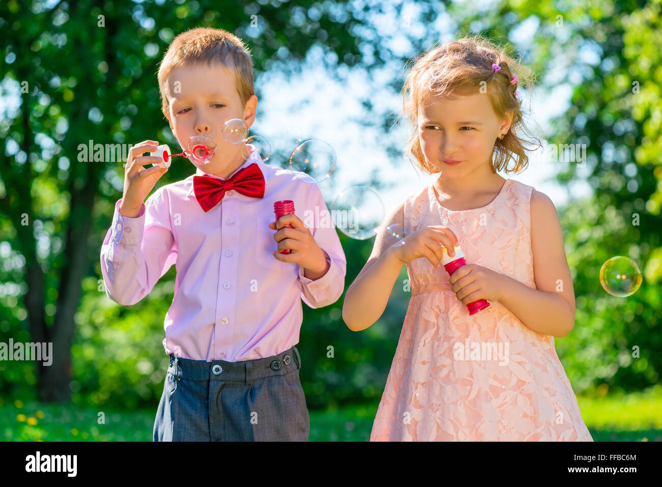 I bambini fino a 6 anni fa le bolle di sapone nel parco Foto Stock