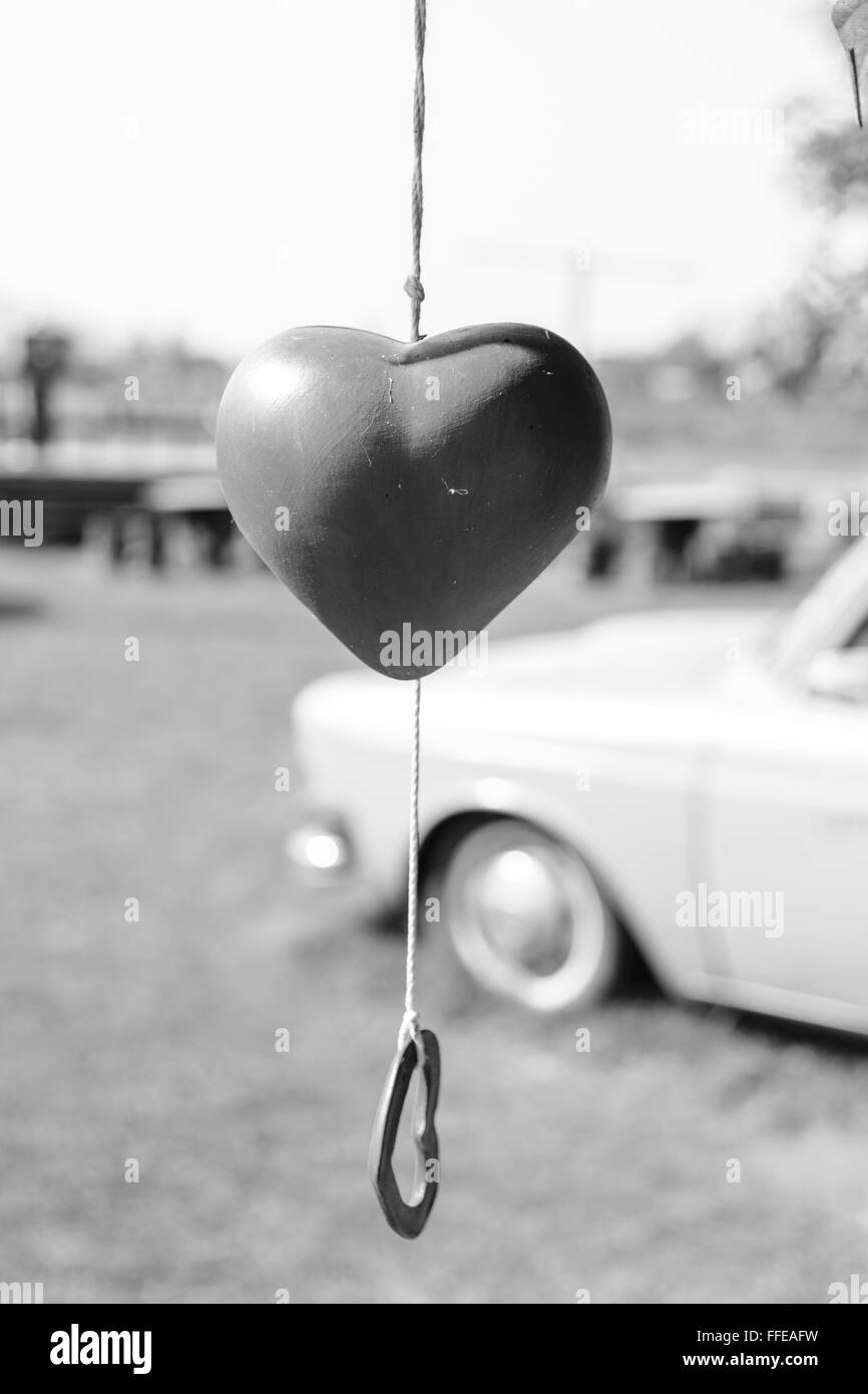 In bianco e nero a forma di cuore appeso a campana sulla struttura ad albero per il giorno di San Valentino. Foto Stock