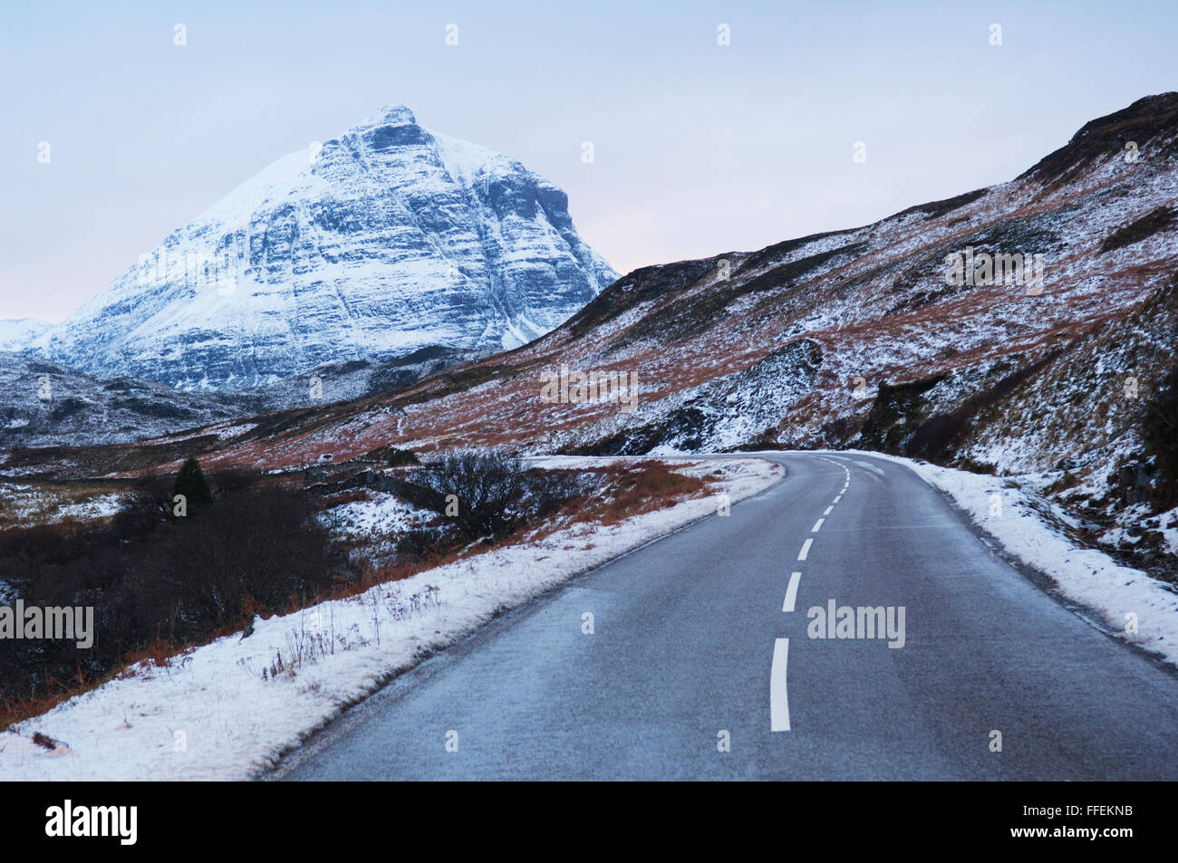 Strada in inverno vicino alla montagna iconica Quinag - Sutherland, Highlands Scozzesi. Parte della costa Nord 500 il percorso. Foto Stock