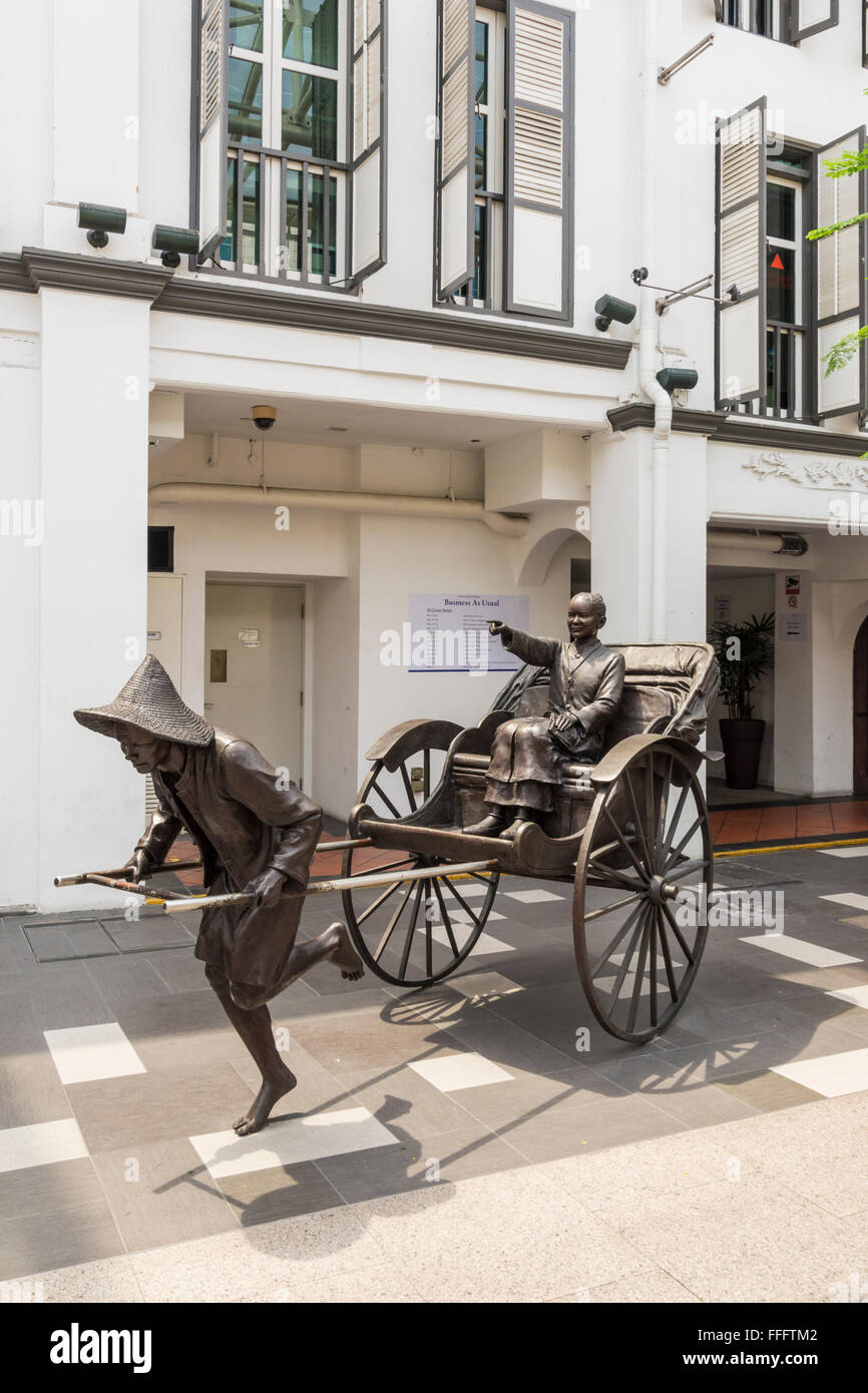 La scultura di un rickshaw estrattore con passeggero, Nankin St, Singapore Foto Stock