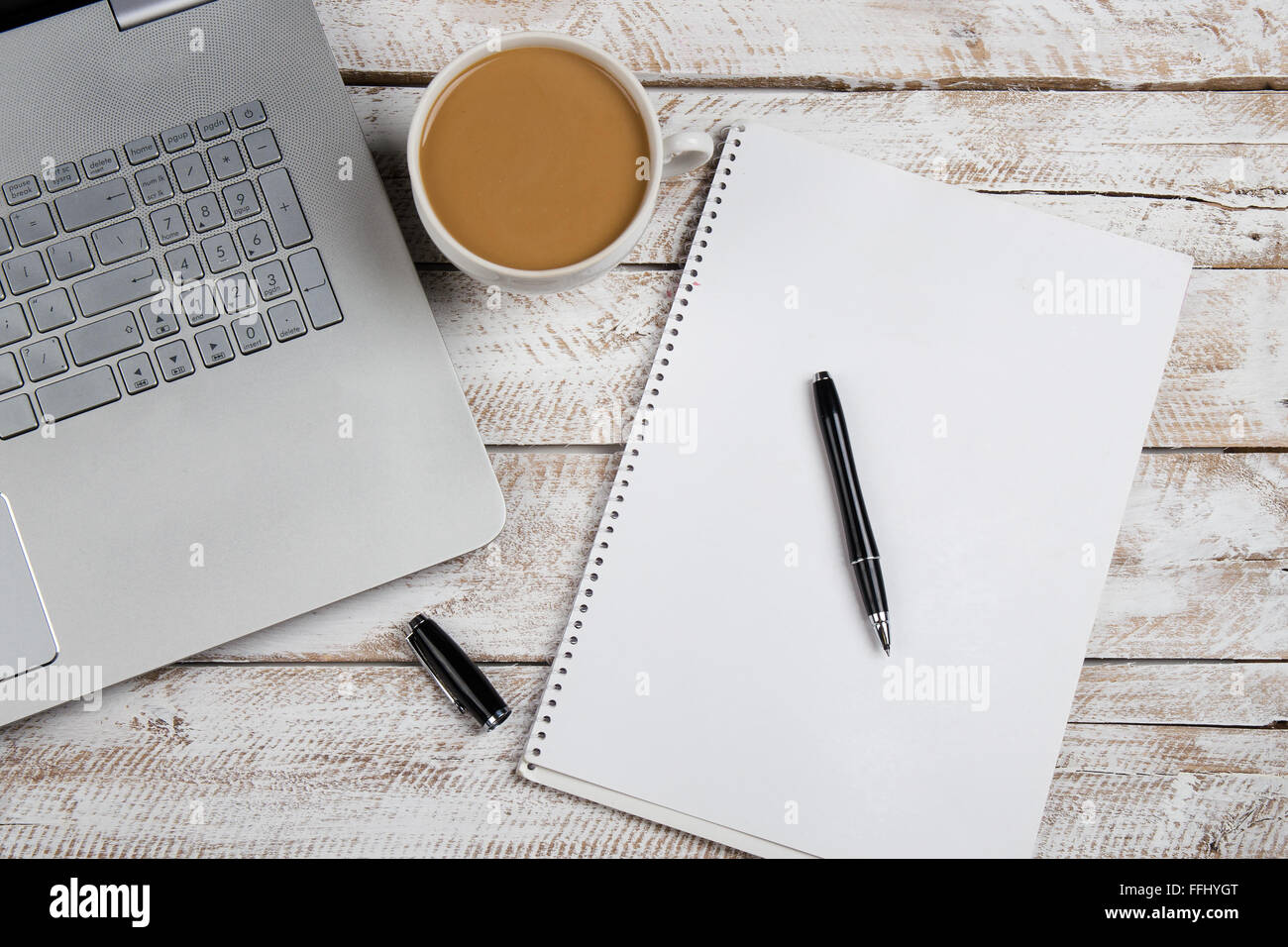 Tazza di caffè e laptop in ufficio in legno tavolo. Immagine di stock. Foto Stock