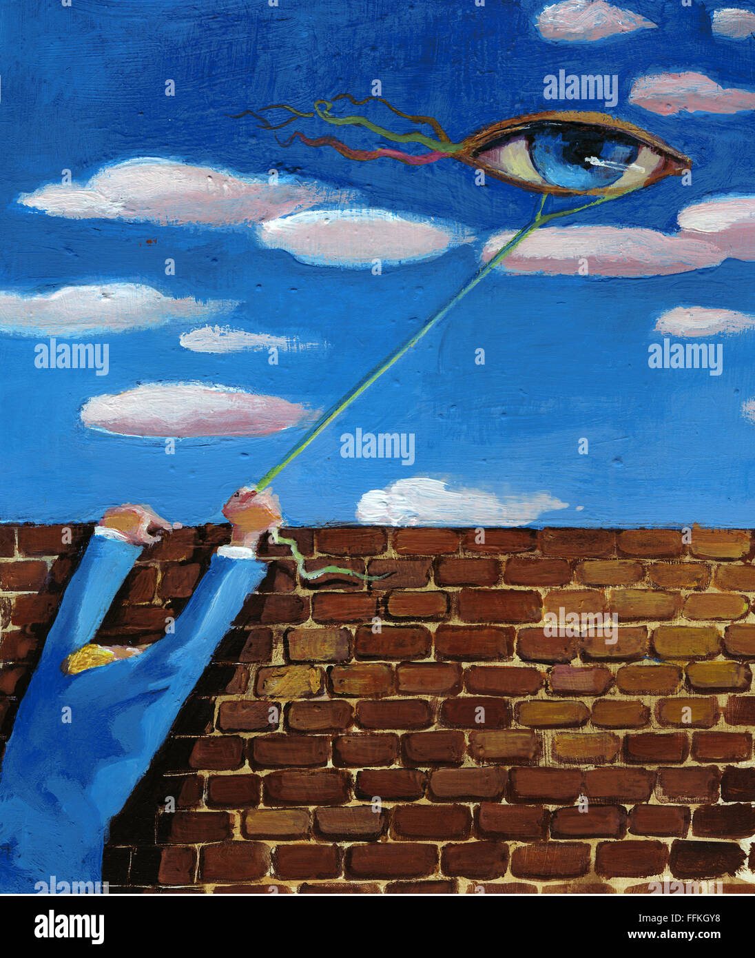 Un uomo dietro una parete rende il volo un aquilone nella forma di un occhio Foto Stock