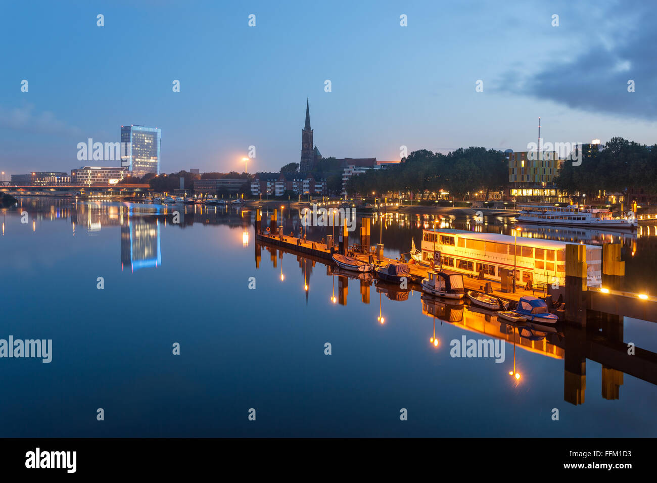 La riflessione di Brema skyline nelle calme acque del fiume Weser di Brema in Germania. Foto Stock