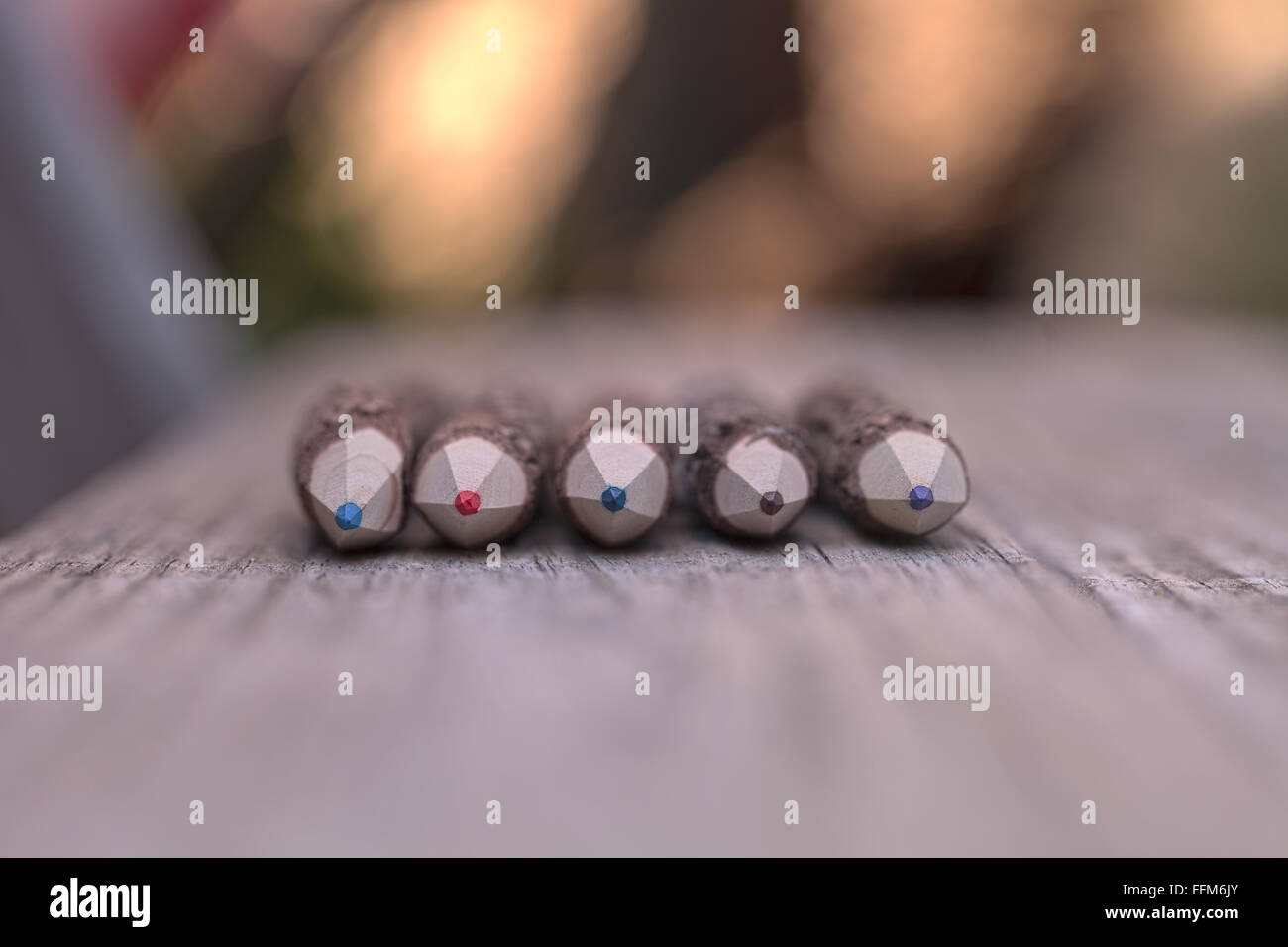 Vista macro di corteccia coperta la matita colorata suggerimenti su un banco di legno sfondo Foto Stock