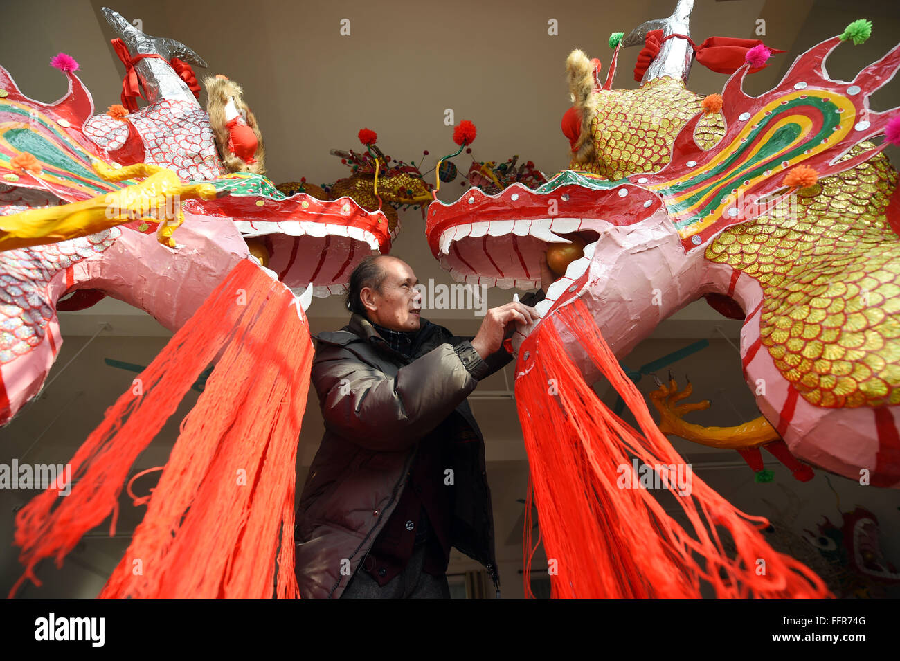 (160217) -- BINYANG, Feb 17, 2016 (Xinhua) -- Handicraftsman Zou Yute decora un drago paolong Binyang nella contea del sud della Cina di Guangxi Zhuang Regione autonoma, Feb 16, 2016. Il Binyang Paolong Festival nazionale di un patrimonio culturale immateriale, viene trattenuto sull'undicesimo giorno del primo mese del calendario lunare cinese ogni anno. Zou Yute, 62 anni, ha ereditato l'artigianato rendendo paolong dragon per più di quarant'anni. Esso tiene almeno venti giorni per rendere paolong drago, che richiede anche la collaborazione di molte persone. Vi sono più di dieci handicraftsmen in Binyang che spec Foto Stock