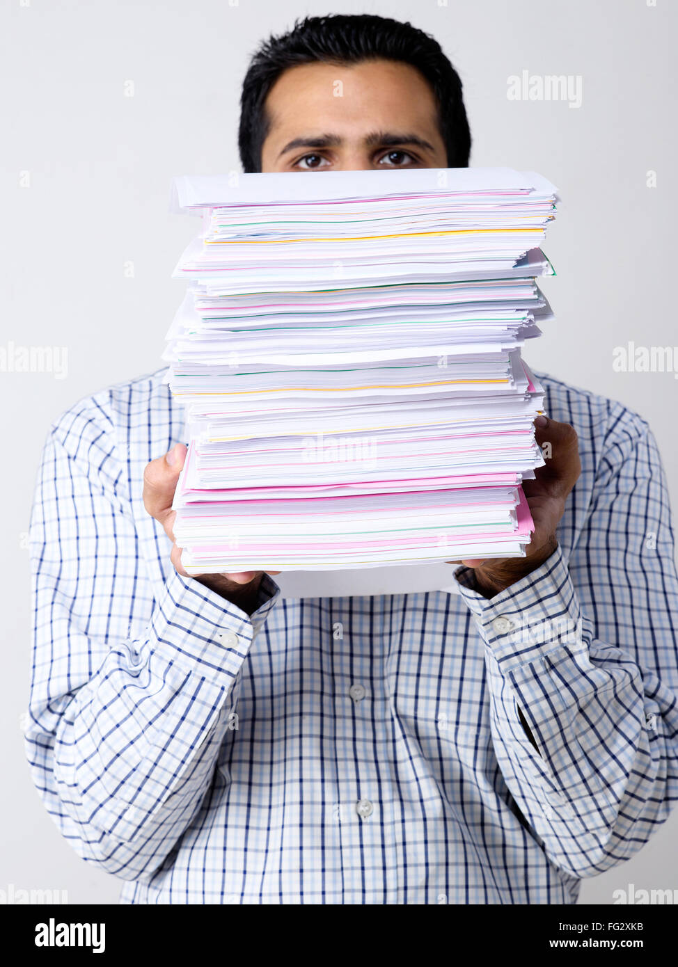 Uomo dietro la pila di carte concetto overwork backlog in attesa di lavoro occupato uomo che trasporta carte lavoro a casa MR#779K Foto Stock