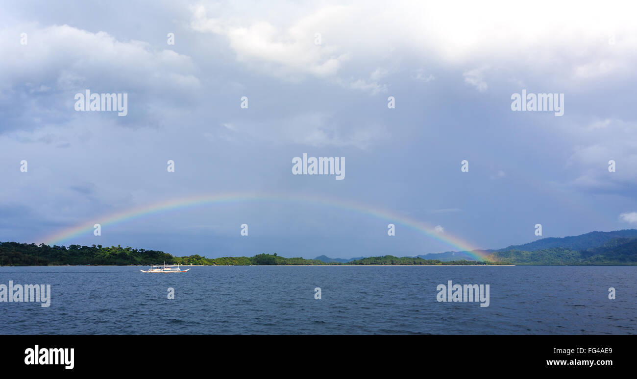 Full Rainbow su isola tropicale nelle Filippine Foto Stock