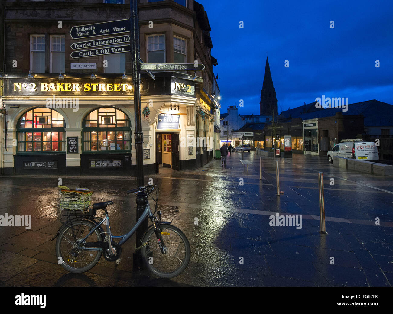 4. febbraio 2016, Baker Street, Stirling, Scozia, scena notturna, noleggio si appoggia contro un cartello stradale vicino n. 2 Baker Street pub. Foto Stock