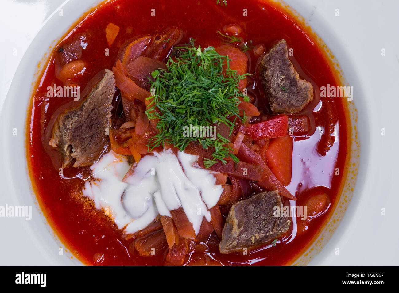 Oriente cucina europea. Ucraino zuppa rossa borscht con panna acida, primo piano Foto Stock