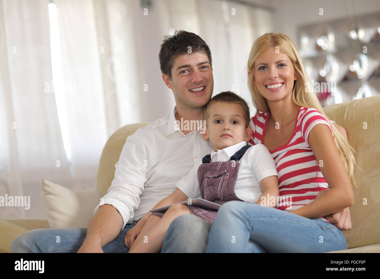 La famiglia a casa utilizzando computer tablet Foto Stock