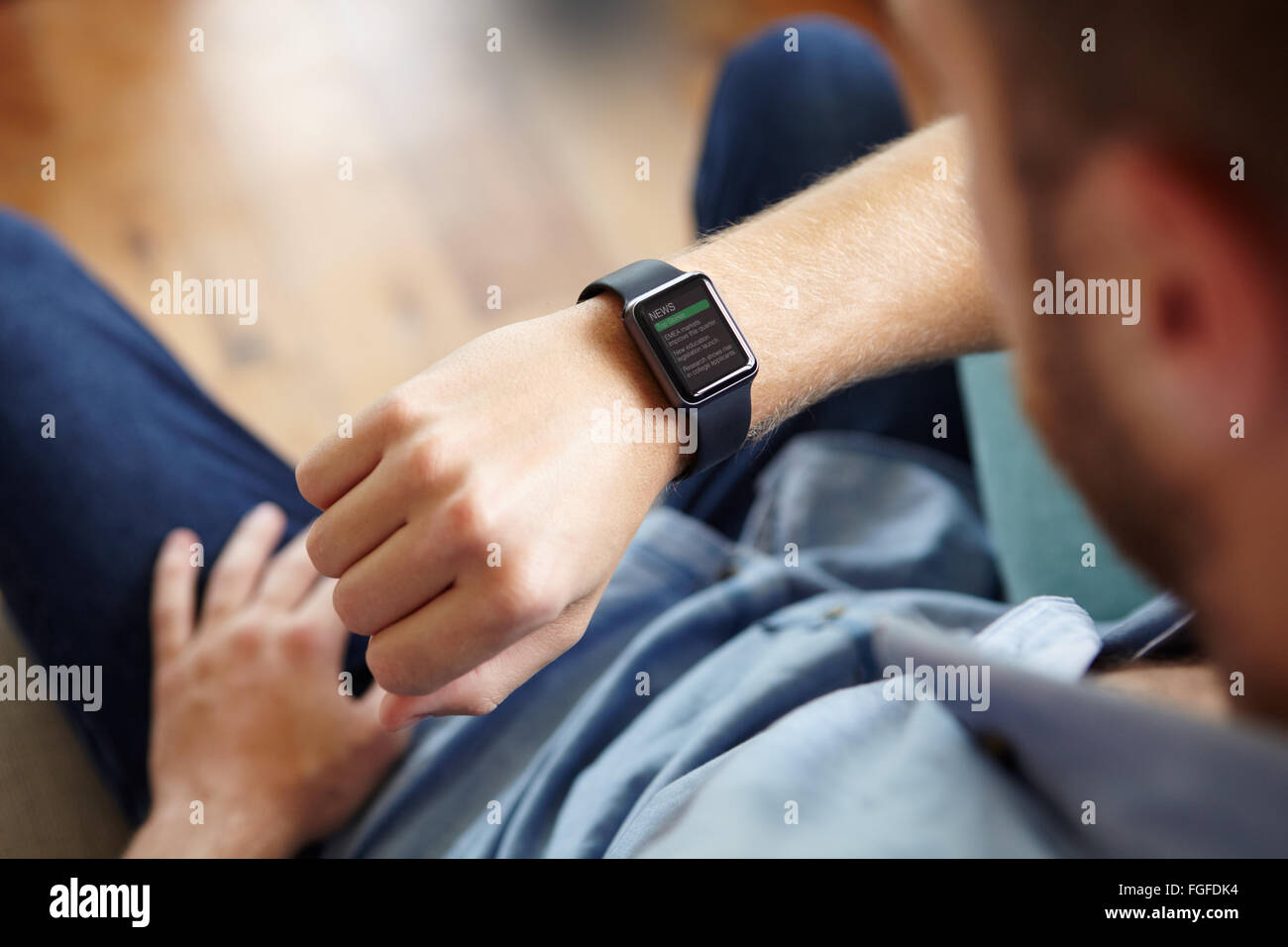 Uomo che guarda News applicazioni software su Smart Watch Foto Stock