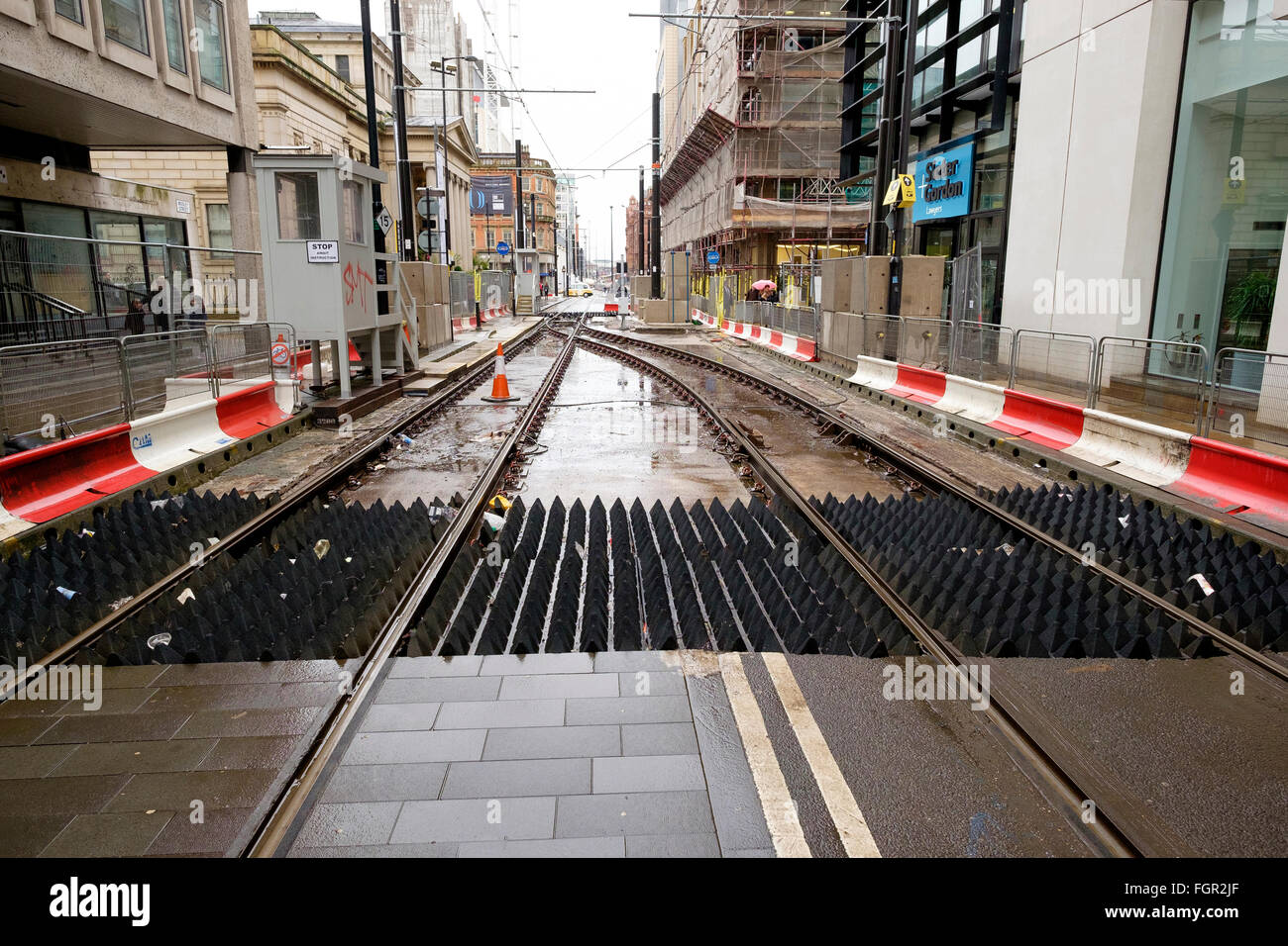 Manchester, Regno Unito - 17 Febbraio 2016: pedonale piede ostacoli su Mosley Street Metrolink di Manchester linea dove durante la croce città Foto Stock