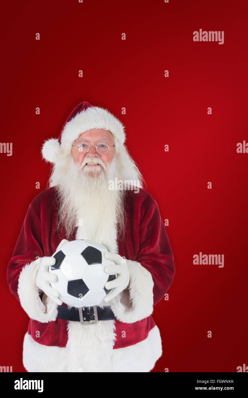 Immagine composita di santa detiene un classico football Foto Stock