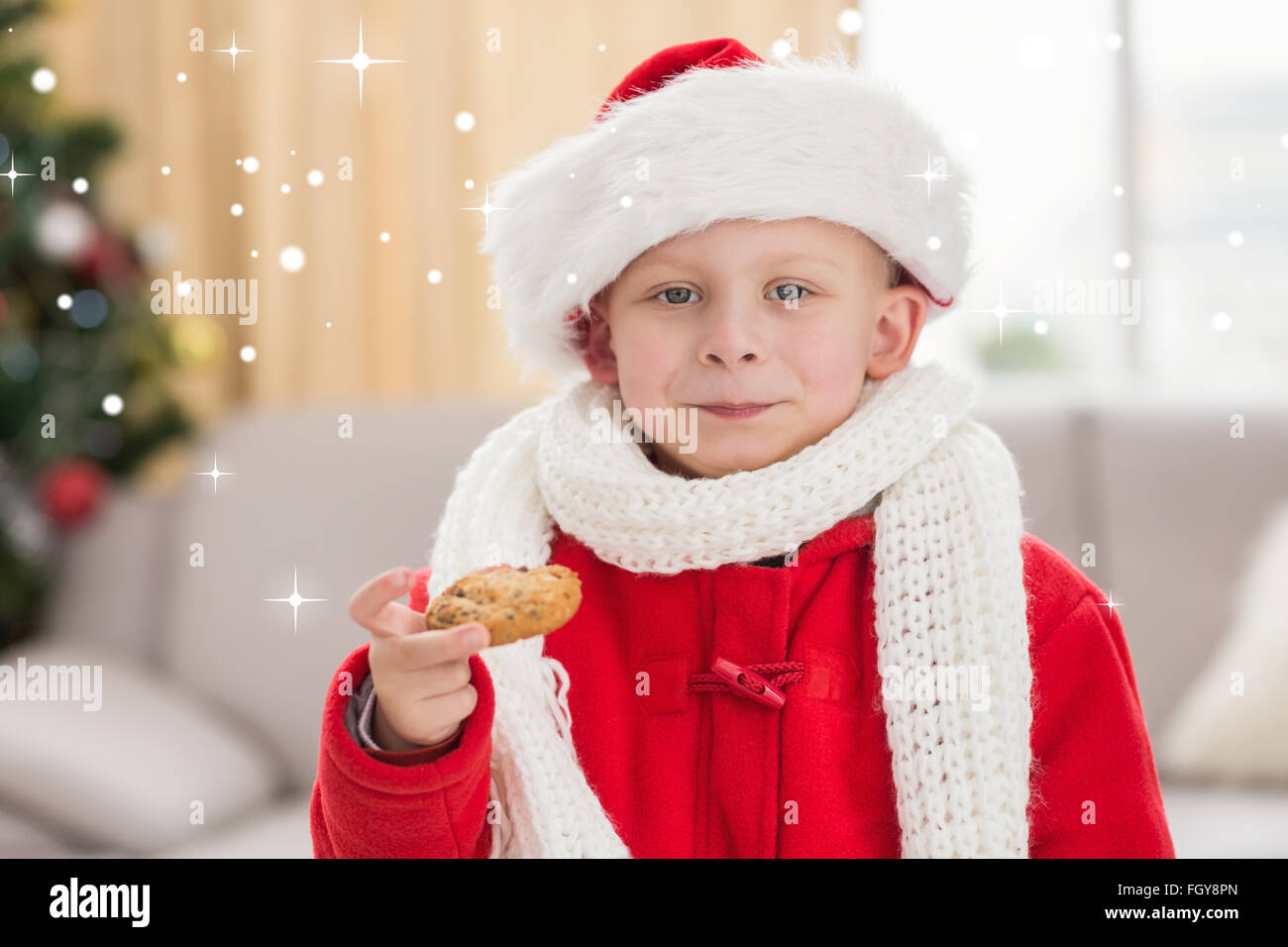 Immagine composita di festosa ragazzino di mangiare un cookie Foto Stock