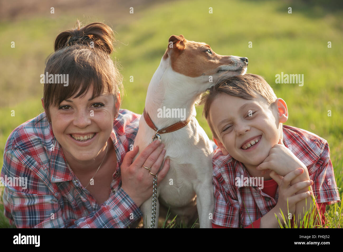 Il figlio e la mamma con il cane in posizione di parcheggio Foto Stock