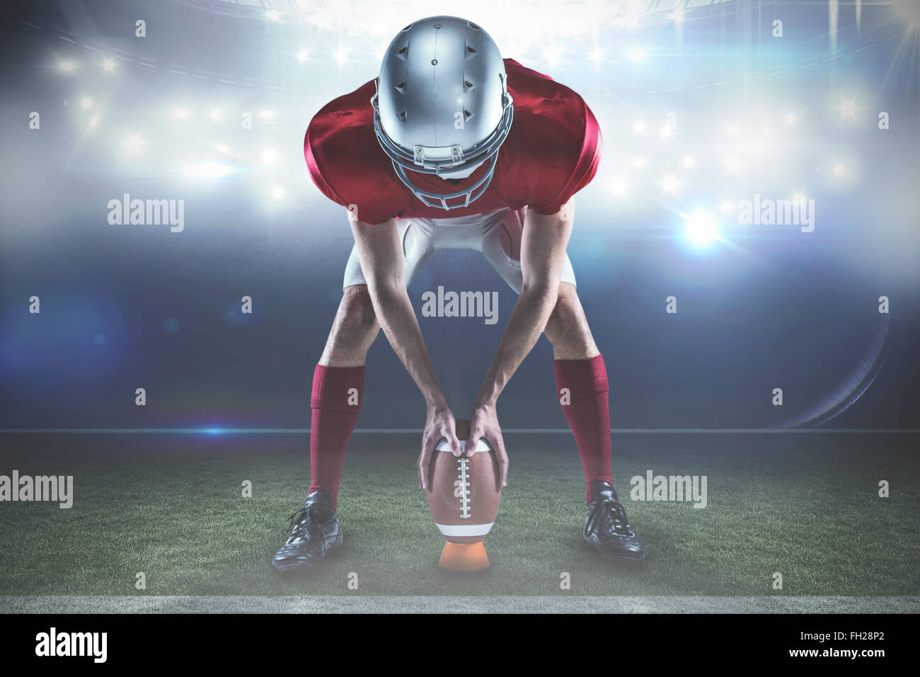 Immagine composita di lunghezza completa di sports player posizionando la palla tra le gambe Foto Stock
