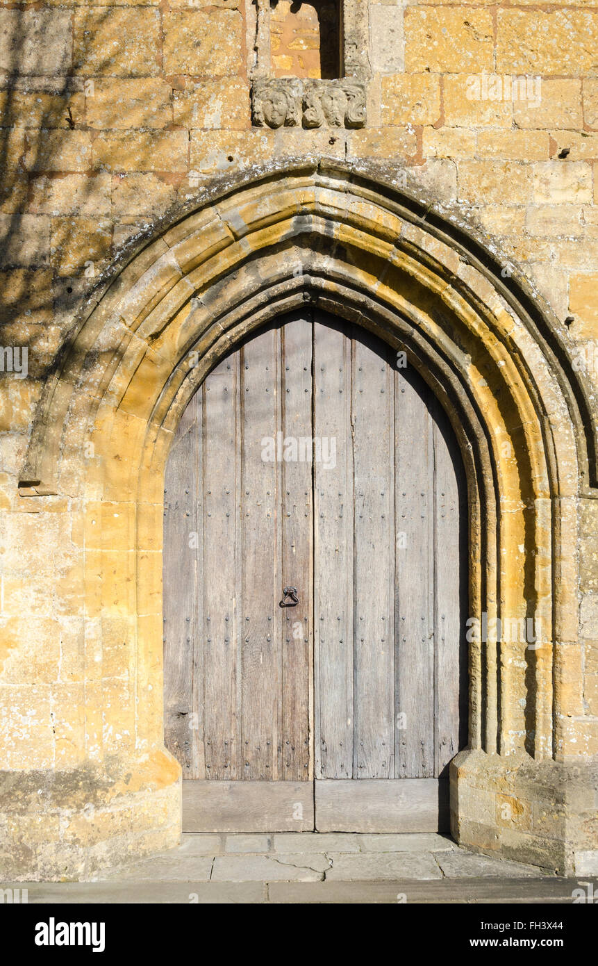 Grande arcata e porte in legno ad ingresso a St James chiesa in Chipping Campden Foto Stock