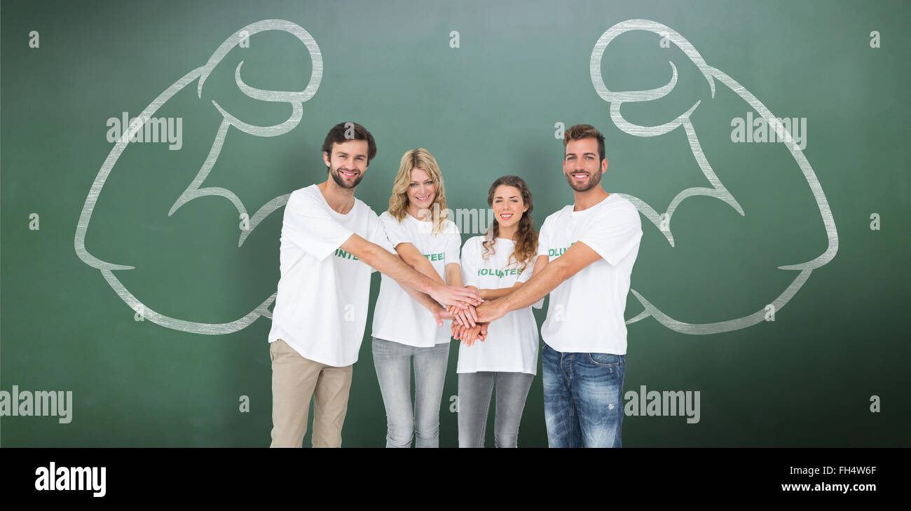 Immagine composita del gruppo ritratto di felice volontari con le mani insieme Foto Stock