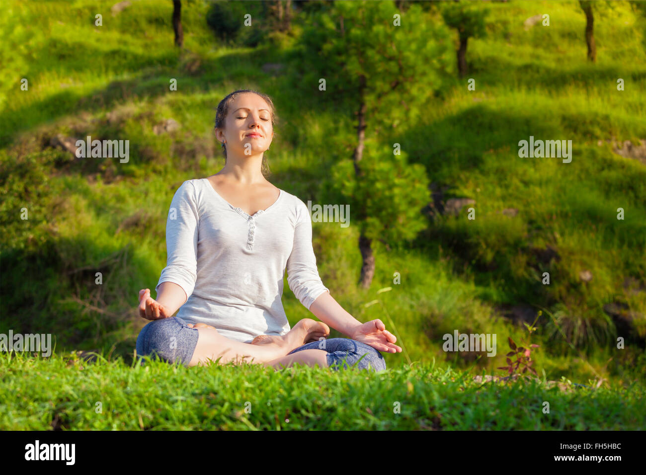 Giovane sportivo da donna adatta per lo yoga Lotus pongono oudoors Foto Stock