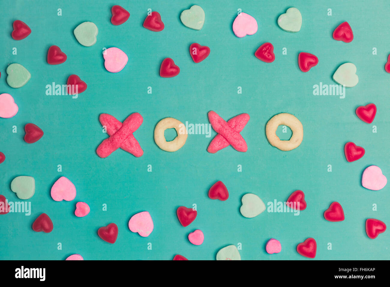 Il giorno di San Valentino XOXO Tipografia cookie e cuori di conversazione su sfondo verde Foto Stock