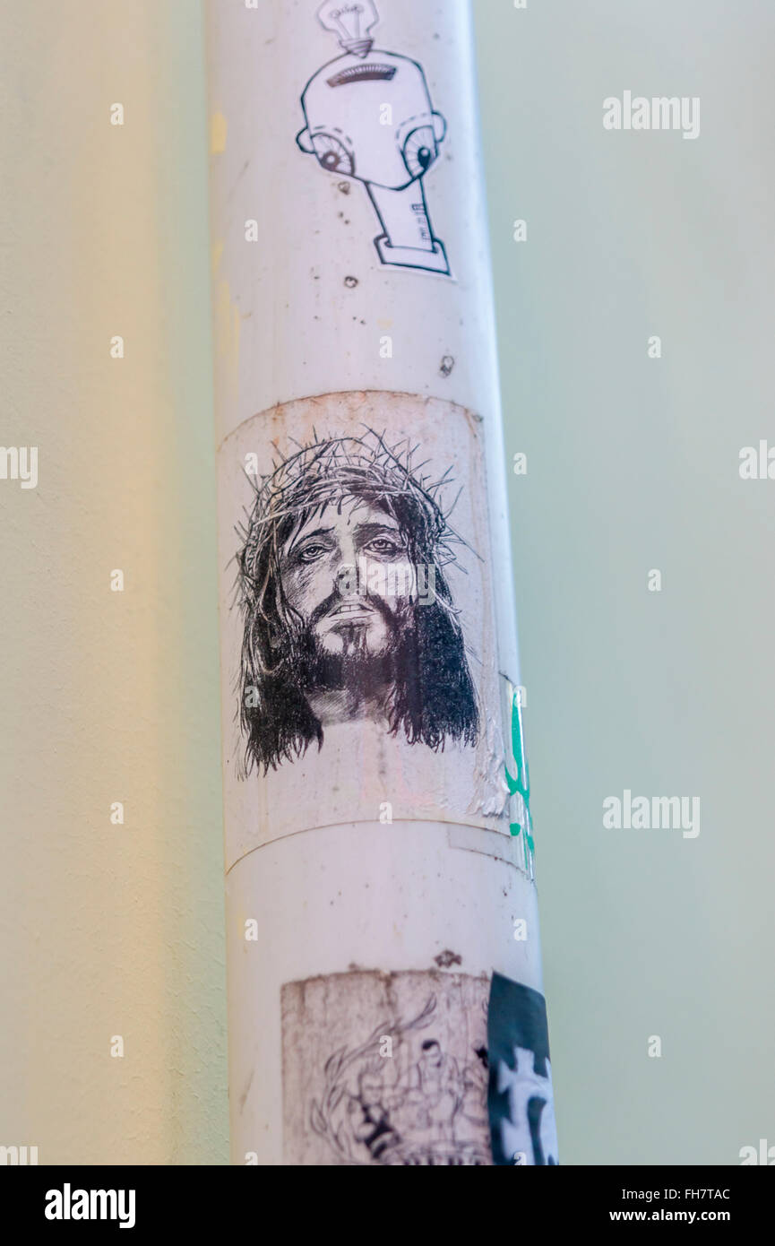 Street Art Stickers, uno che mostra Gesù Cristo che indossa una corona di spine Foto Stock