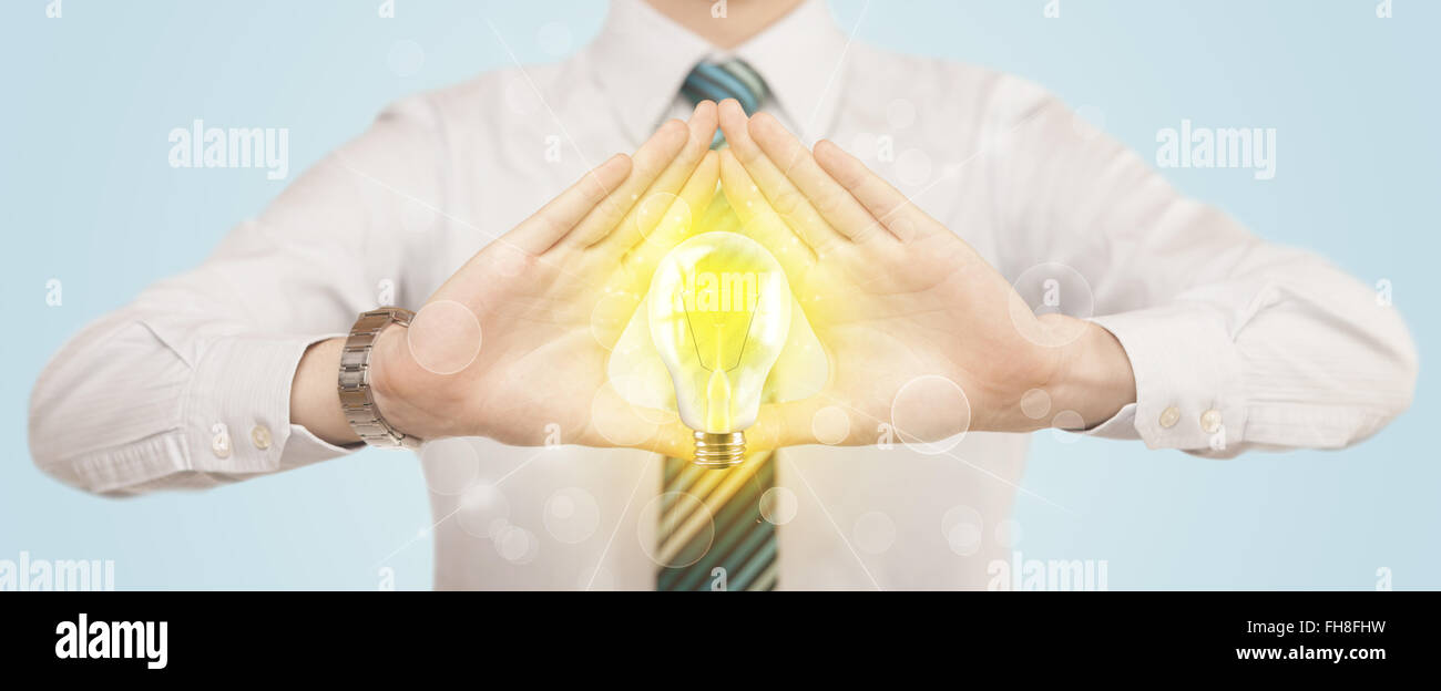 Le mani la creazione di un form con lampadina Foto Stock