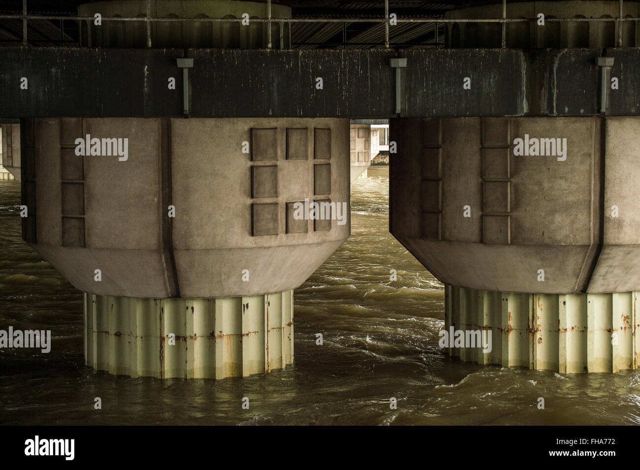 Ponte delle colonne di supporto che sorge fuori del fiume Foto Stock