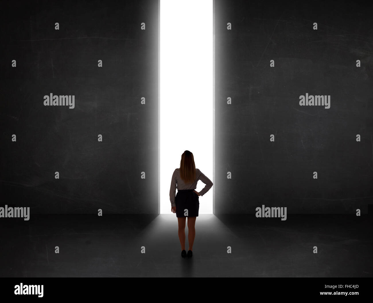 Persona d'affari guardando a parete con la luce di apertura del tunnel Foto Stock