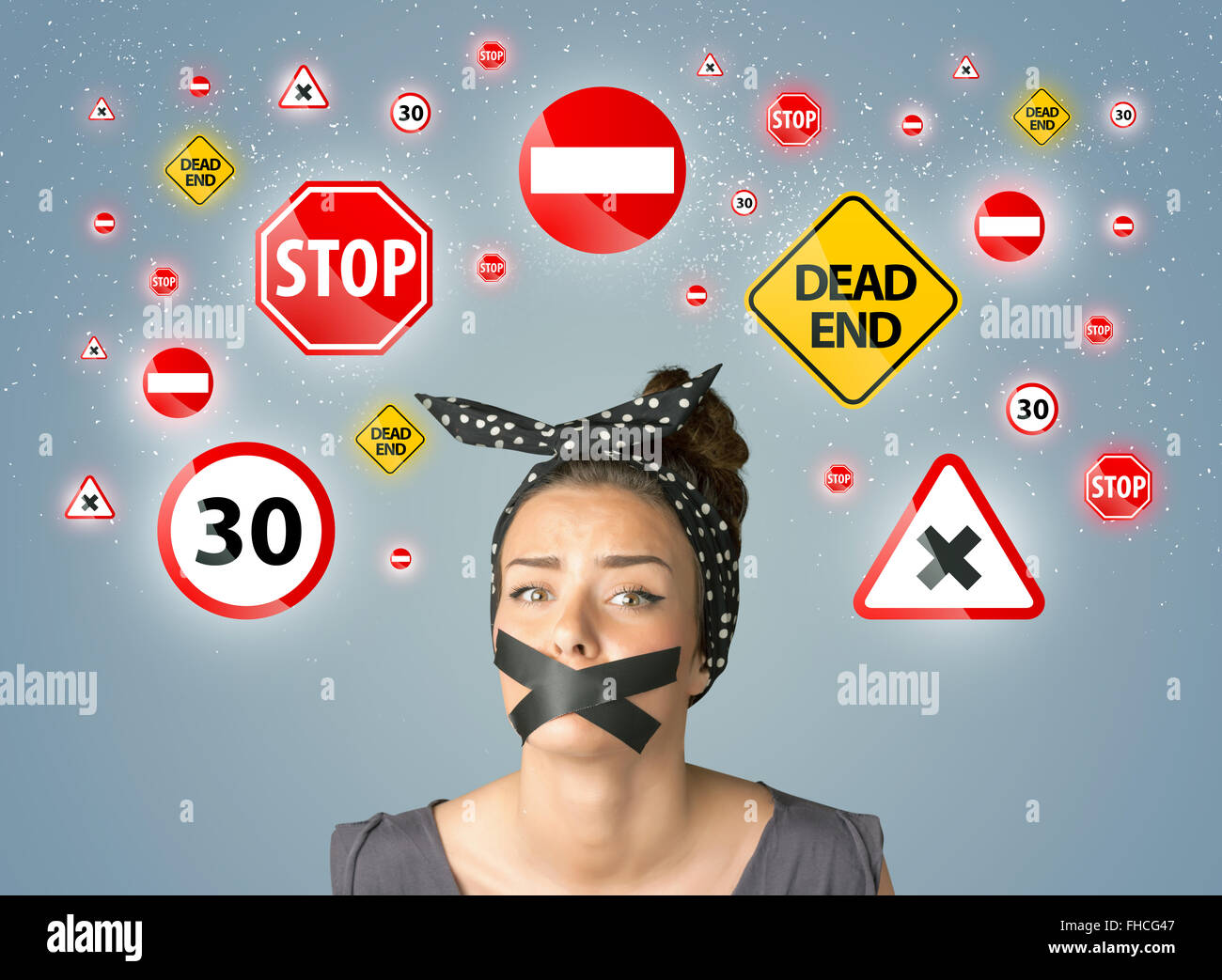 Giovane donna con incollata la bocca e il traffico di segnali Foto Stock