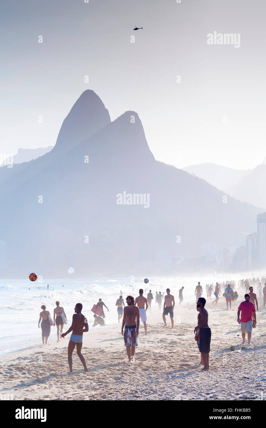 Sud America, Brasile, Rio de Janeiro Ipanema, persone calcio su una spiaggia affollata Foto Stock