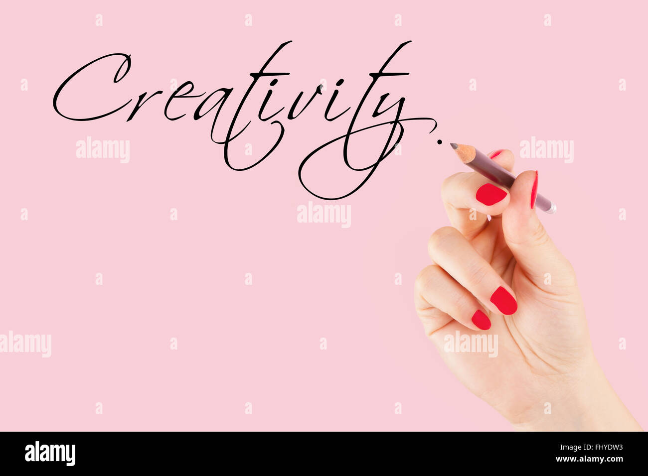 Industrie creative. Femmina con mano una matita a scrivere la parola creatività in caligraphy. Foto Stock