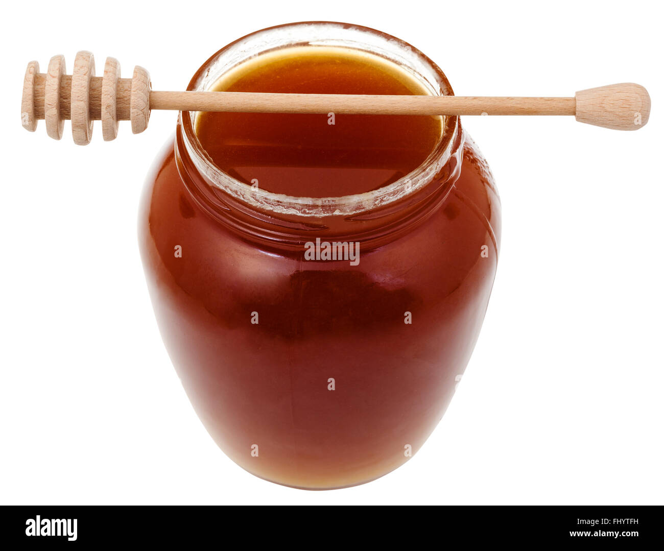 Il vasetto di vetro marrone con il miele e il bastone di legno isolato su sfondo bianco Foto Stock