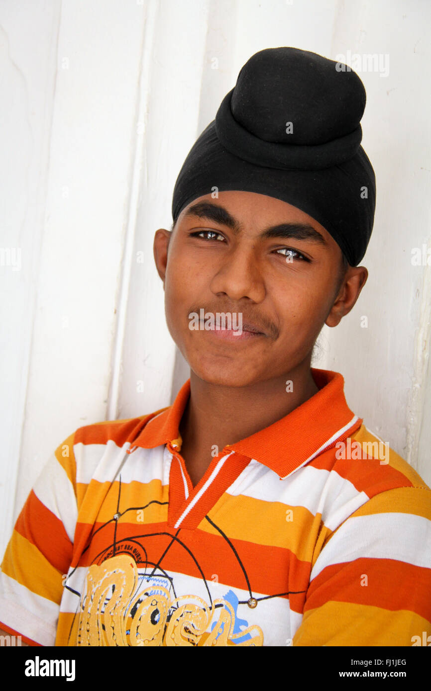 Giovane uomo Sikh con turbante nel tempio d'oro, Amritsar , India Foto Stock