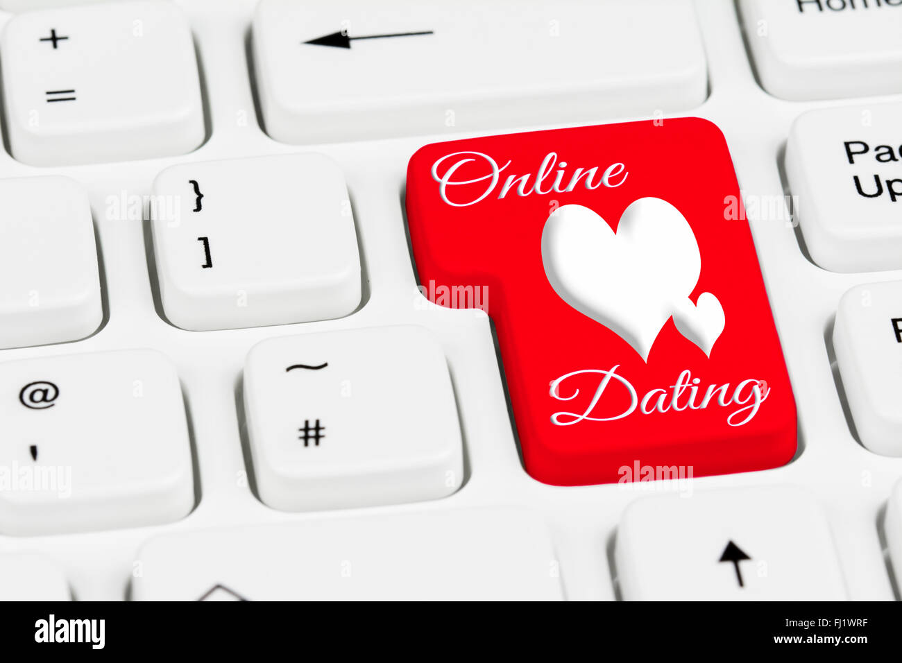 Online dating pulsante su un bianco della tastiera del computer. Foto Stock