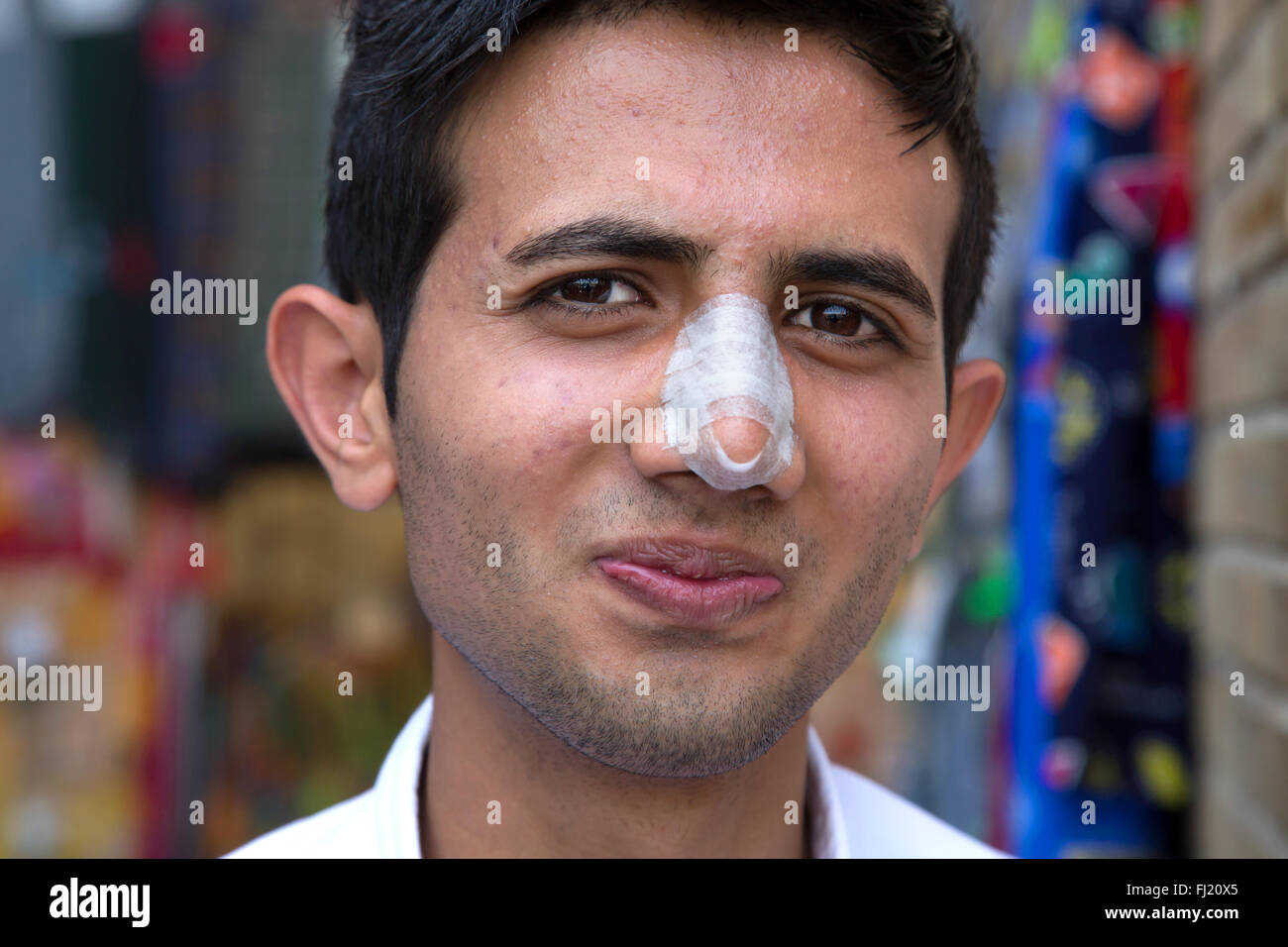 Ritratto di uomo iraniano con bendaggio a causa dei recenti naso chirurgia plastica, Iran Foto Stock