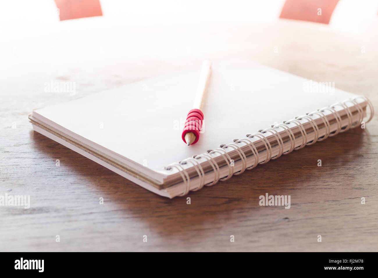 Stazione di lavoro con notebook e matita con filtro vintage, stock photo Foto Stock