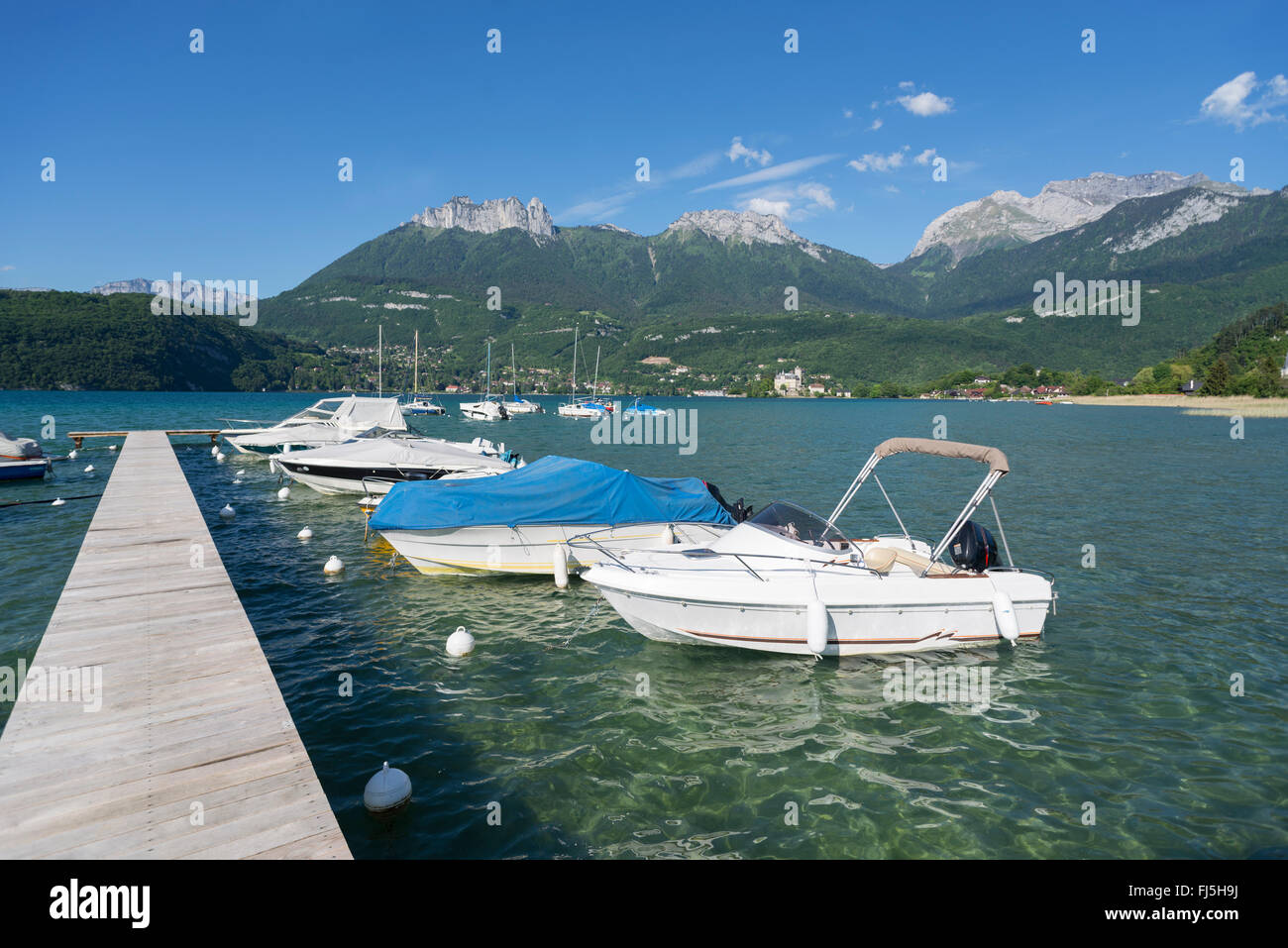 Il molo di Duingt presso il lago di Annecy con Duingt castello e un panorama con le montagne di Savoyan Tournette e ammaccature du Lanfon Foto Stock