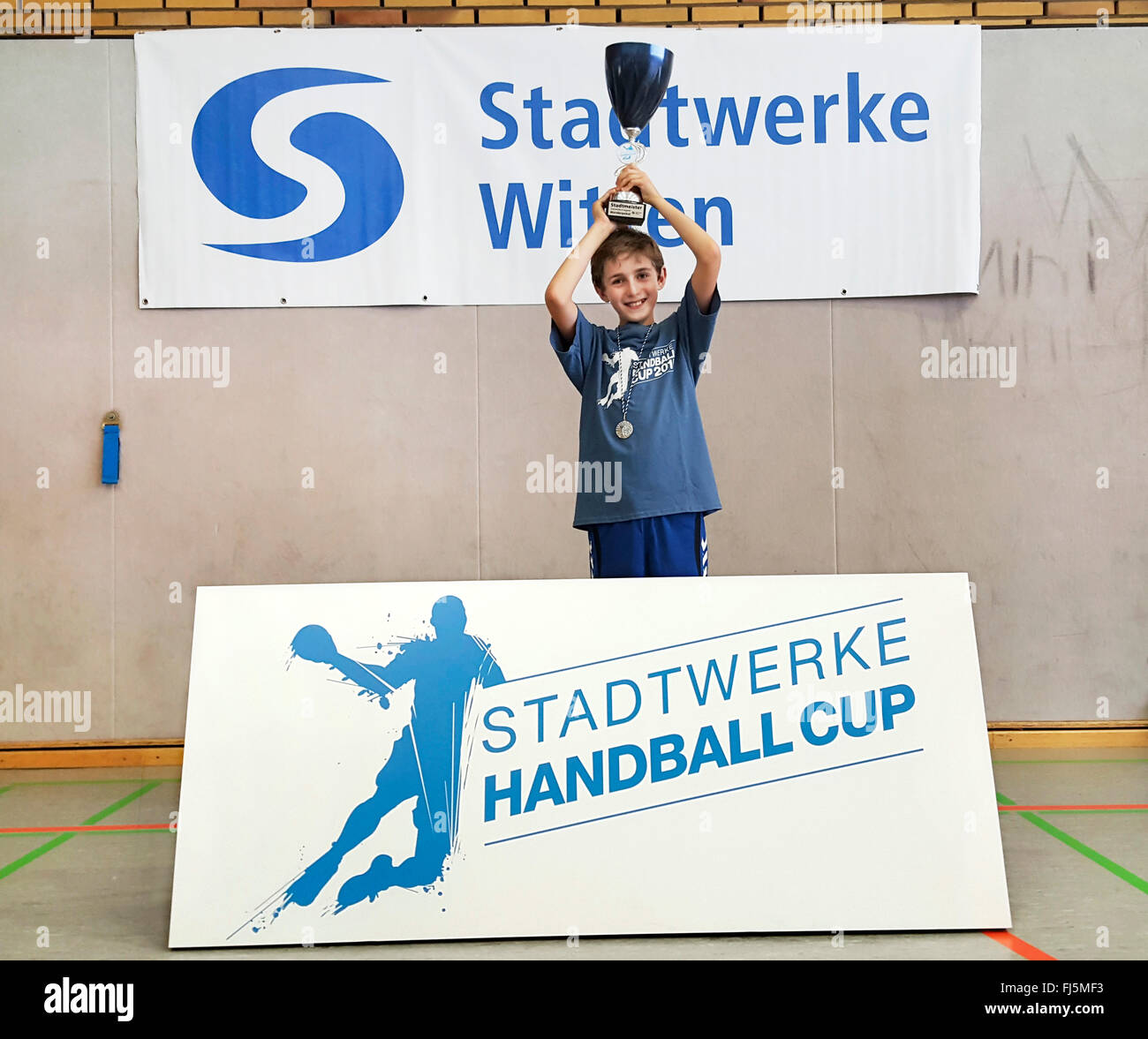 Ragazzo mantenendo orgogliosamente un premio coppa, ritratto di un bambino, la zona della Ruhr, Witten Foto Stock