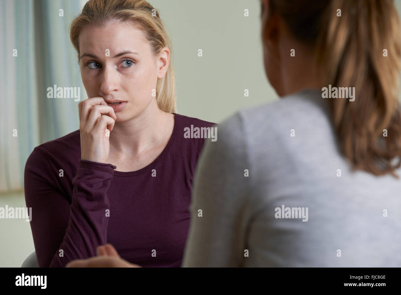 Giovane donna a discutere di problemi con consigliere Foto Stock