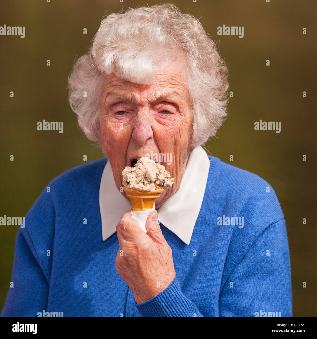 Una signora anziana di mangiare un gelato nel Regno Unito Foto Stock