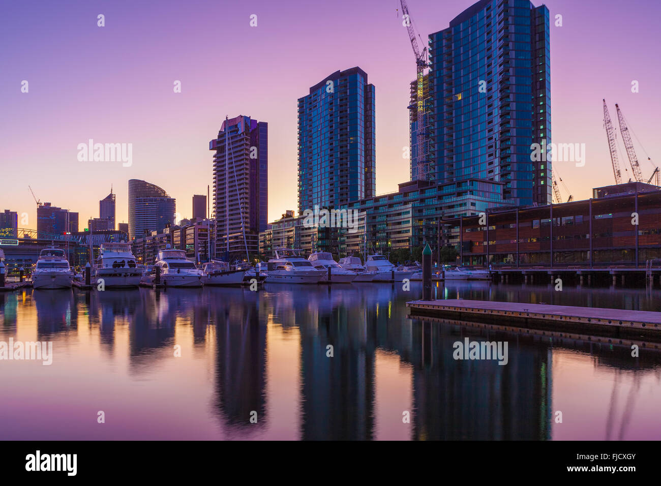 Docklands, Melbourne elevato aumento di edifici residenziali e gli yacht ormeggiati all'alba Foto Stock