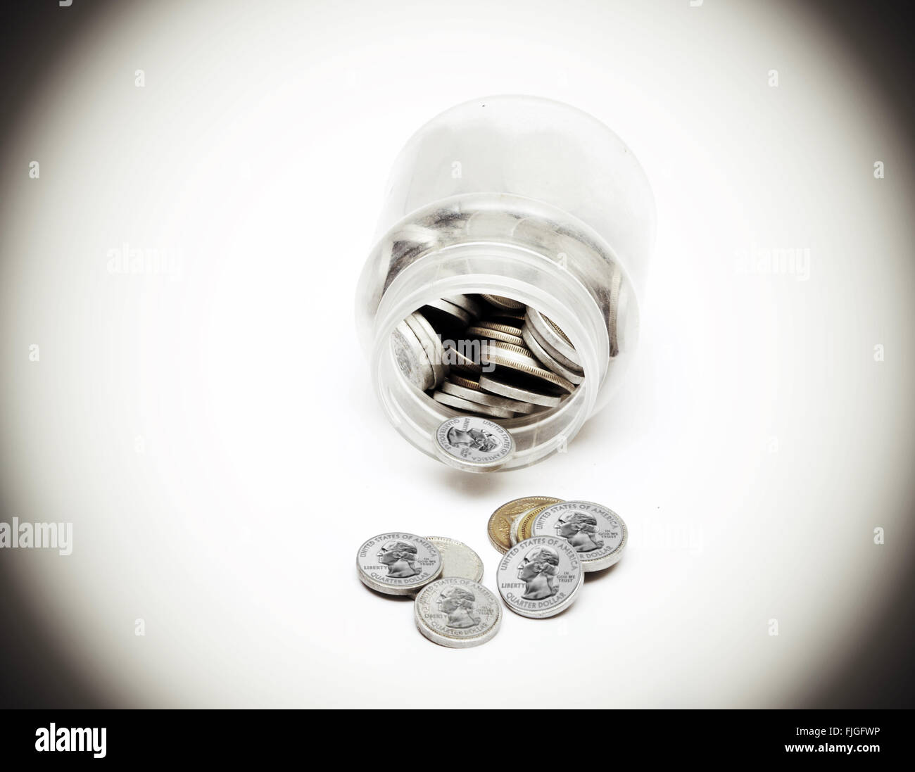 Monete della moneta americana proveniente al di fuori del vaso di risparmio. Foto Stock