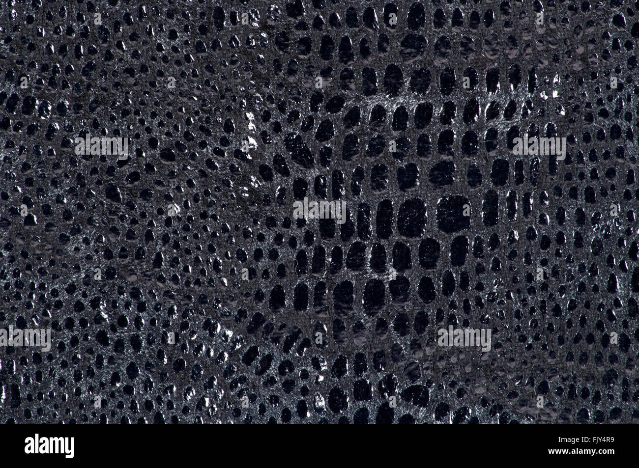 Tessuto nero con motivo coccodrillo background closeup Foto Stock