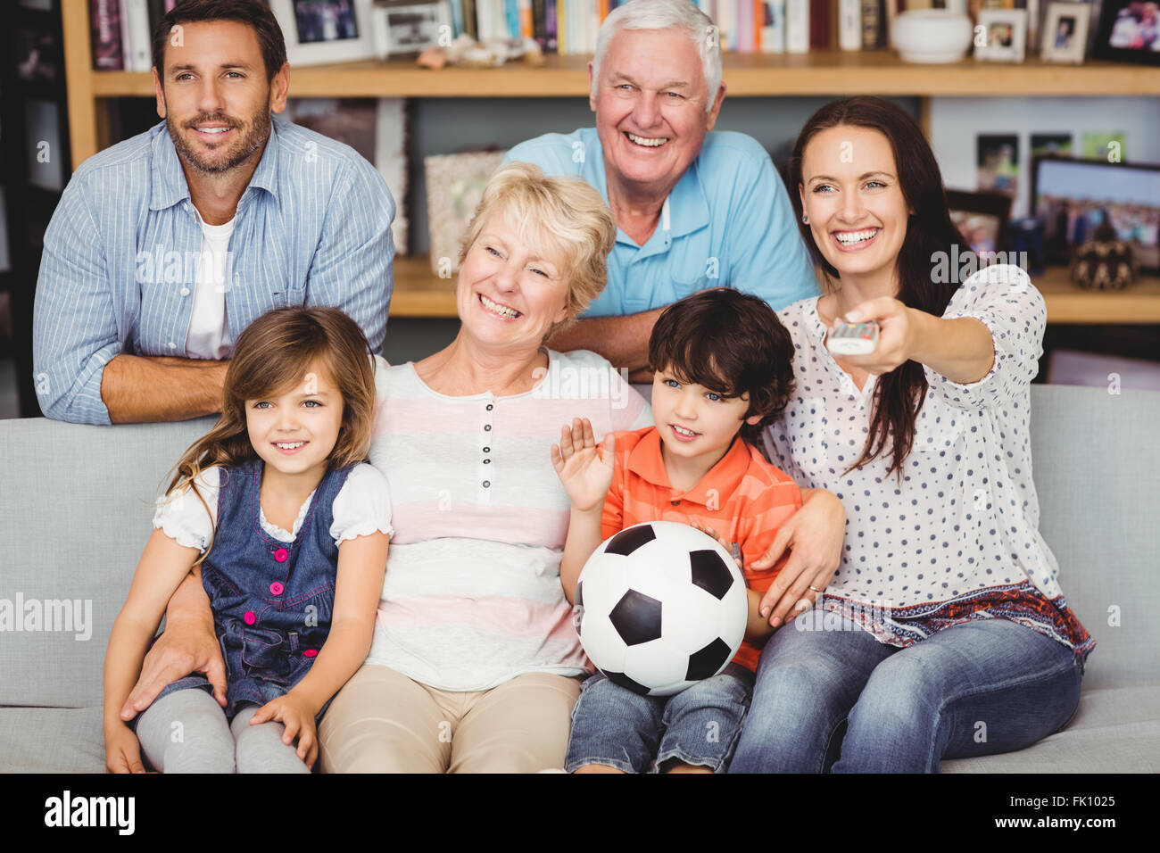 Famiglia sorridente guardando la partita di calcio Foto Stock