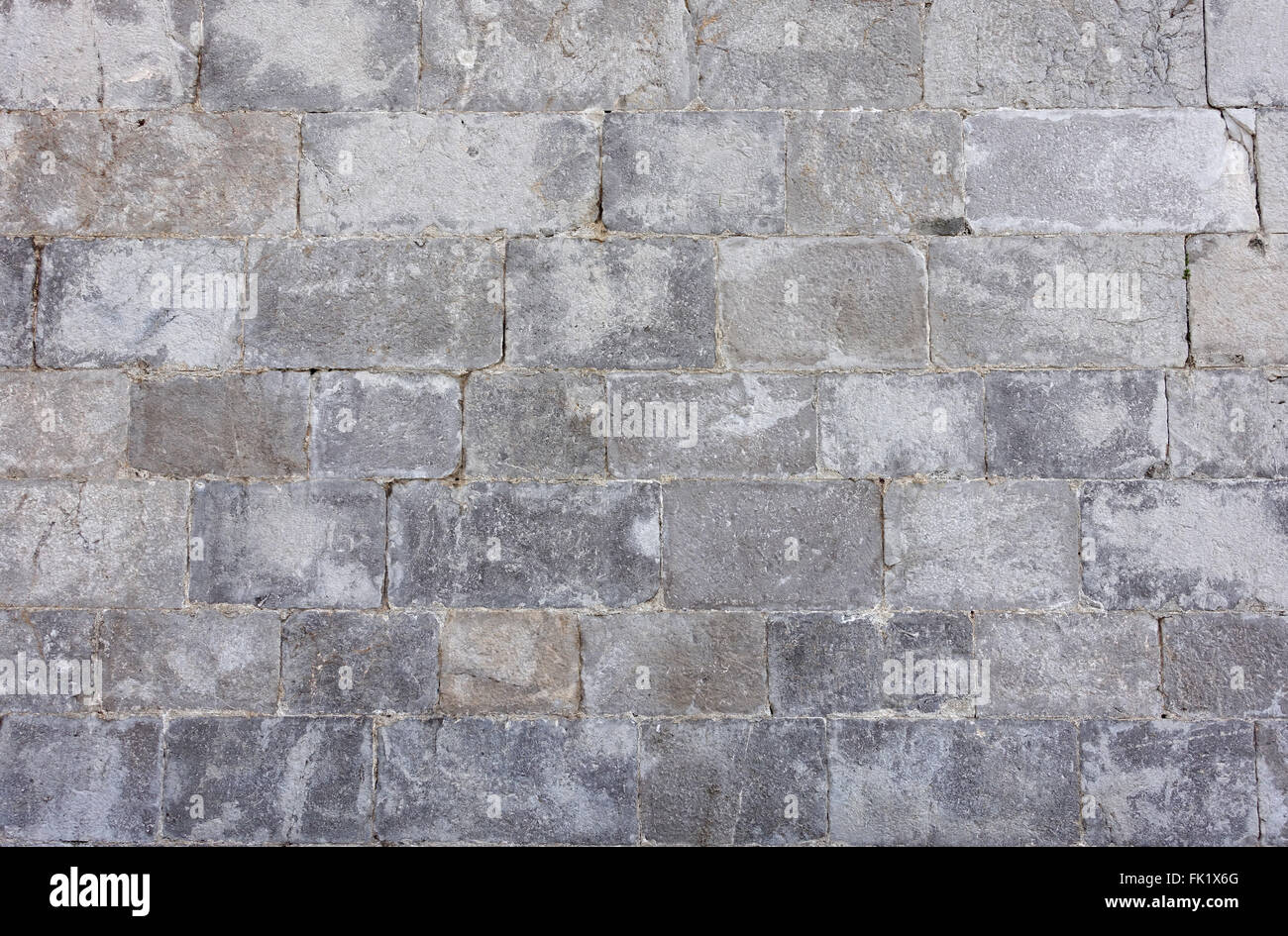 Muro di pietra costituito da grandi blocchi di granito. Parte del vecchio le difese del mare in Gibilterra Foto Stock