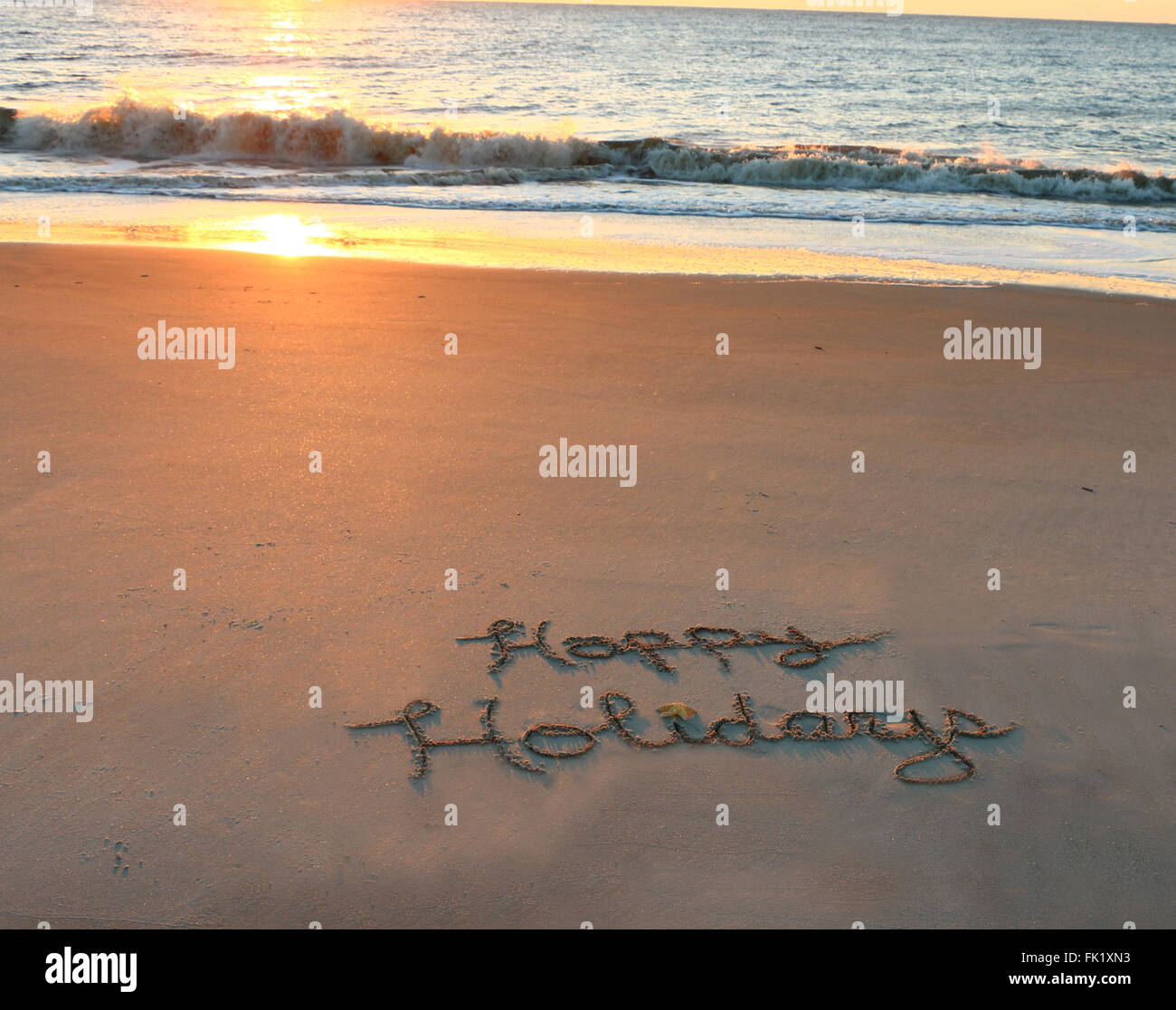 Buone Vacanze scritto in sabbia sulla spiaggia Foto Stock