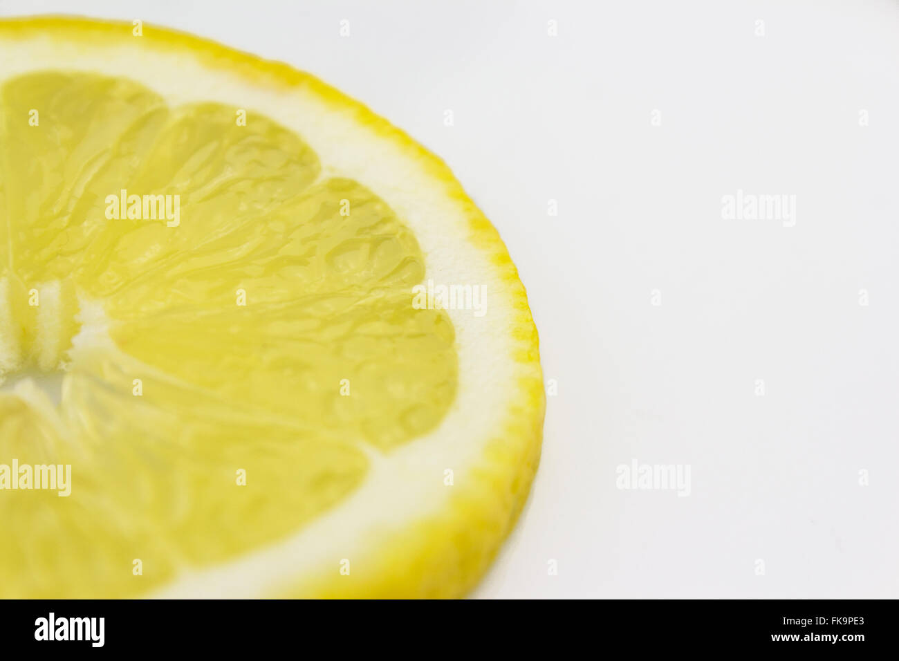 Fettina di limone closeup su sfondo bianco Foto Stock